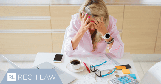 stressed woman with head in hands